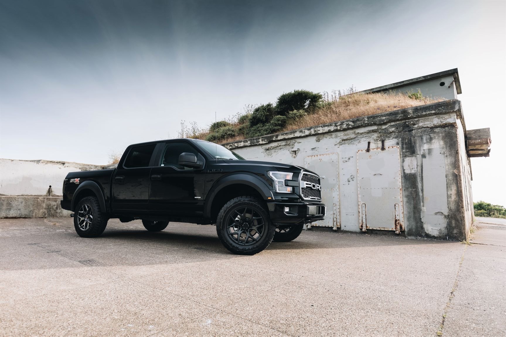 Black Lifted Ford F-150 with Aftermarket Headlights - Photo by Venom Rex