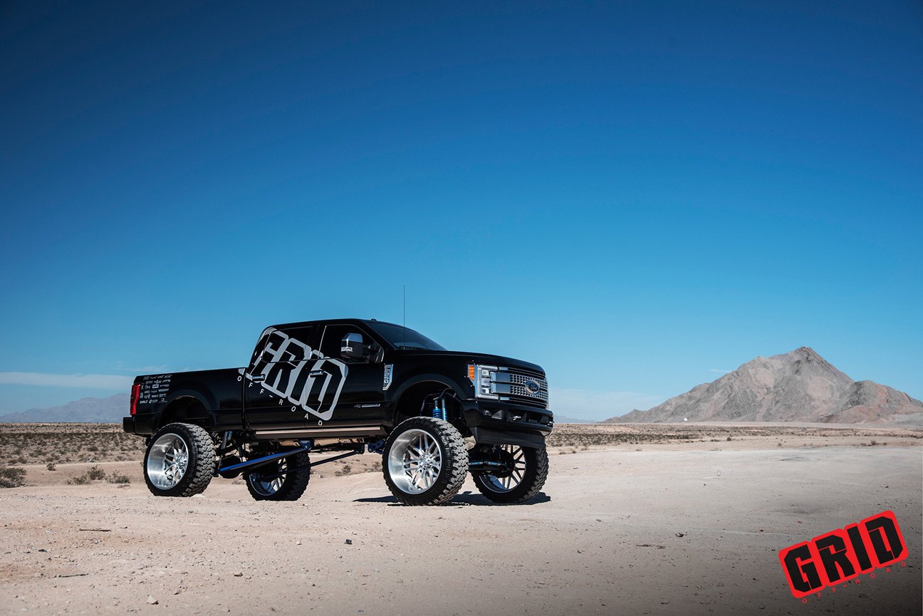 Black Lifted Ford F-250 with Custom Running Boards - Photo by Grid Off-Road