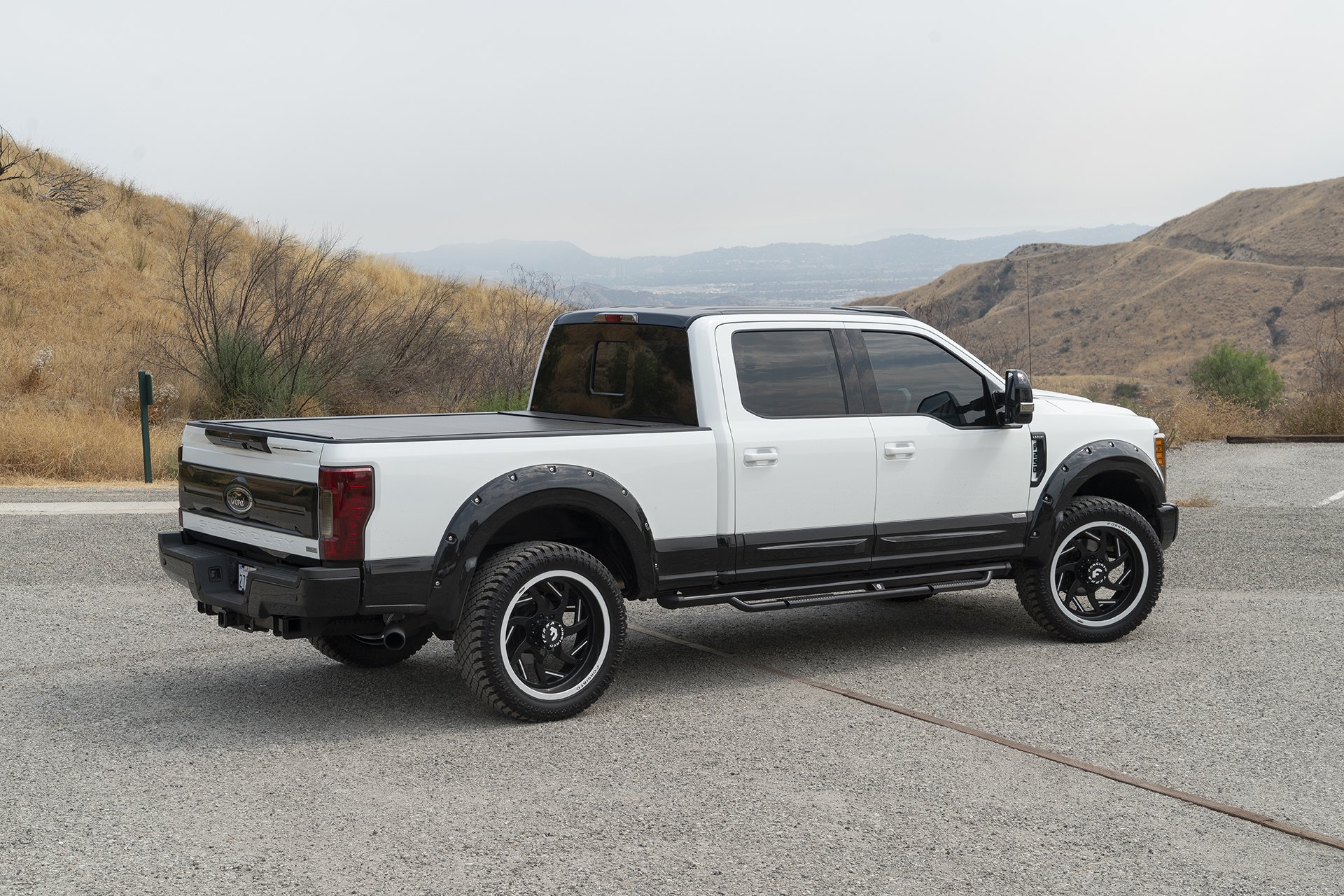 White Ford F-250 with Aftermarket Nerf Steps - Photo by Forgiato