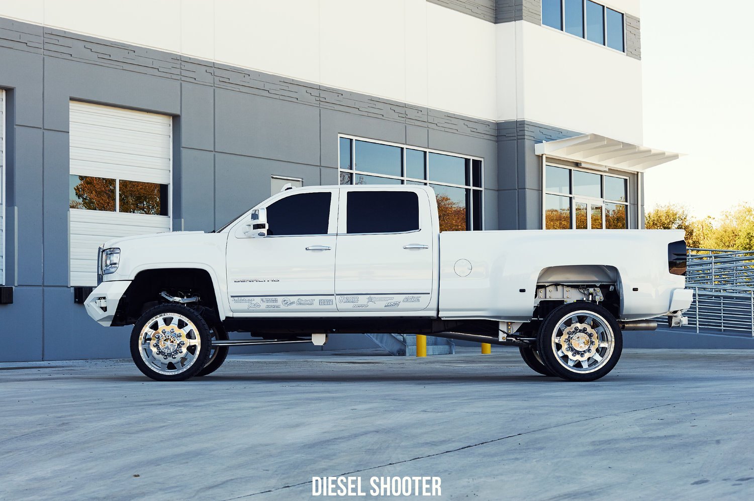 White GMC Sierra with AMP Research Power Steps - Photo by Diesel Shooter