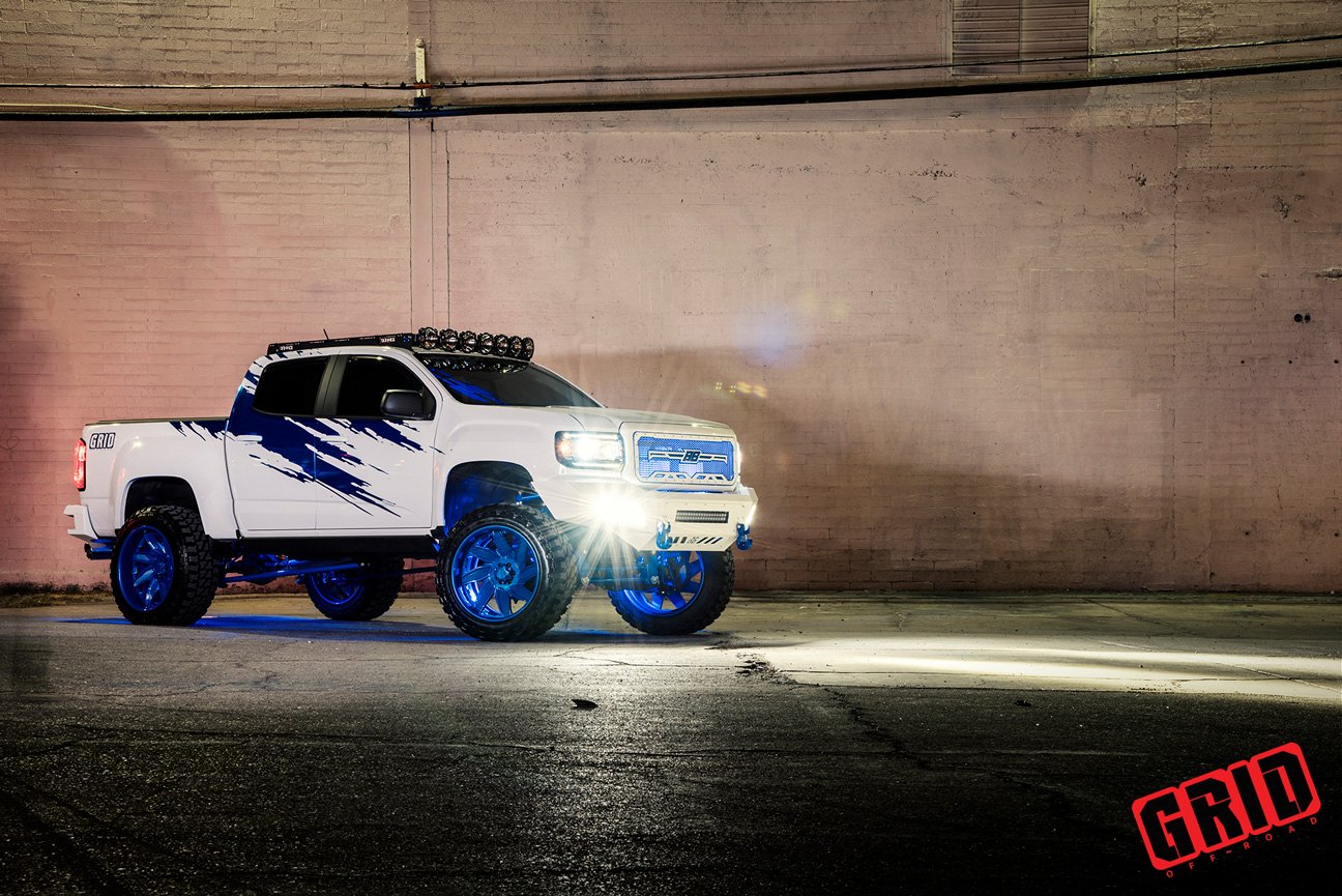 White Lifted GMC Sierra with Aftermarket LED Headlights - Photo by Grid Off-Road