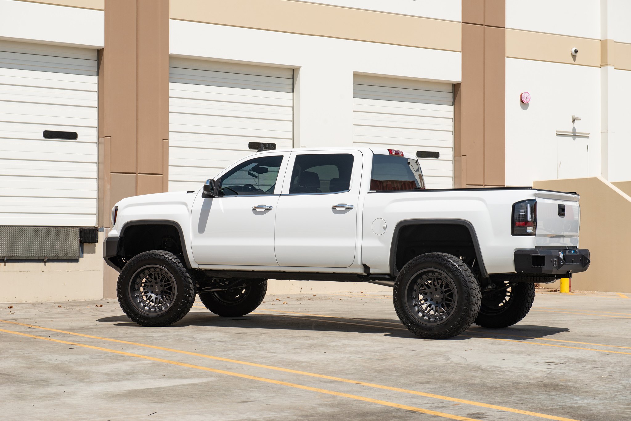 White Lifted GMC Sierra with Retractable Running Boards - Photo by Black Rhino Wheels