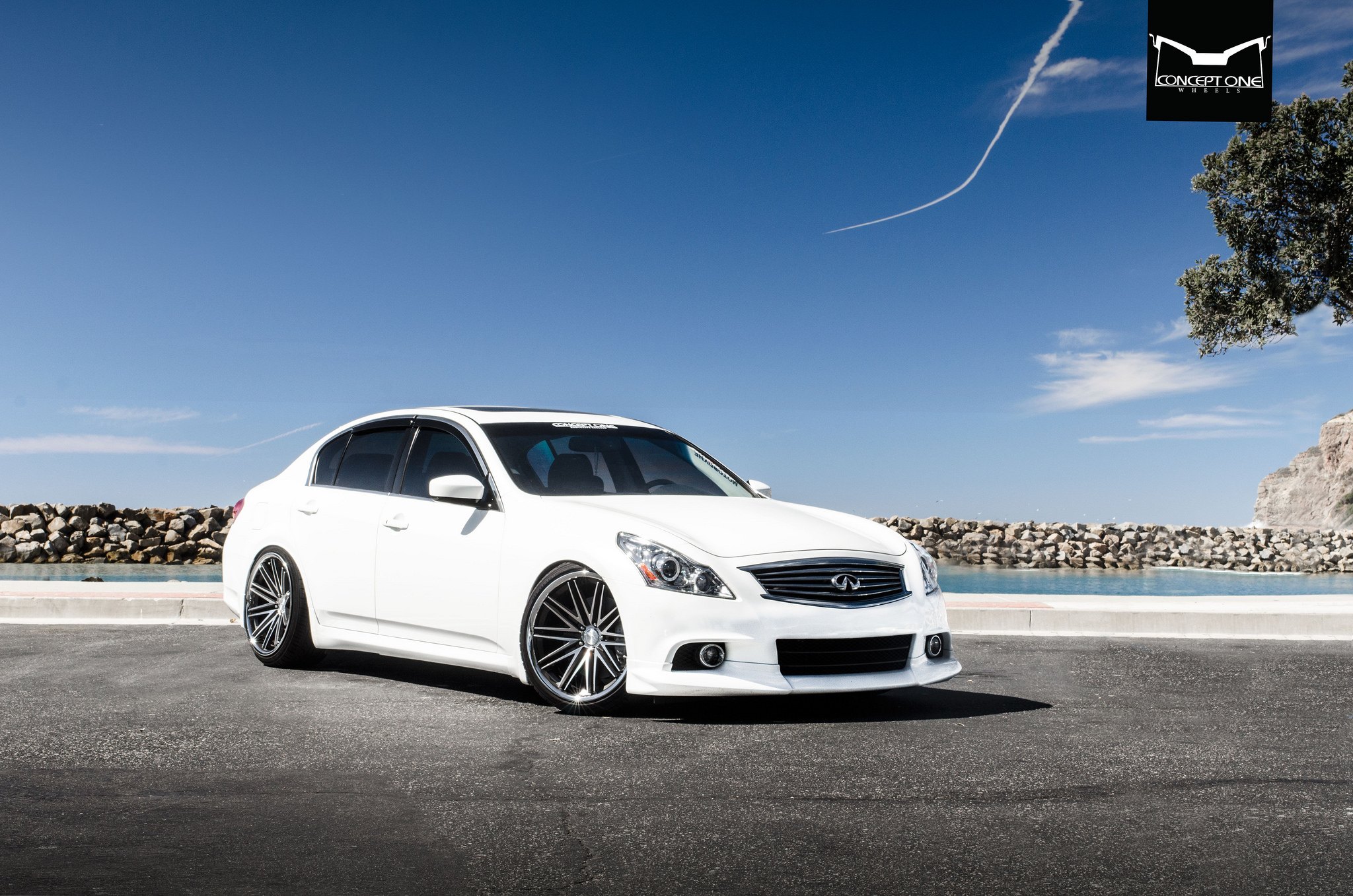 White Infiniti G37 with Aftermarket Projector Headlights - Photo by Concept One