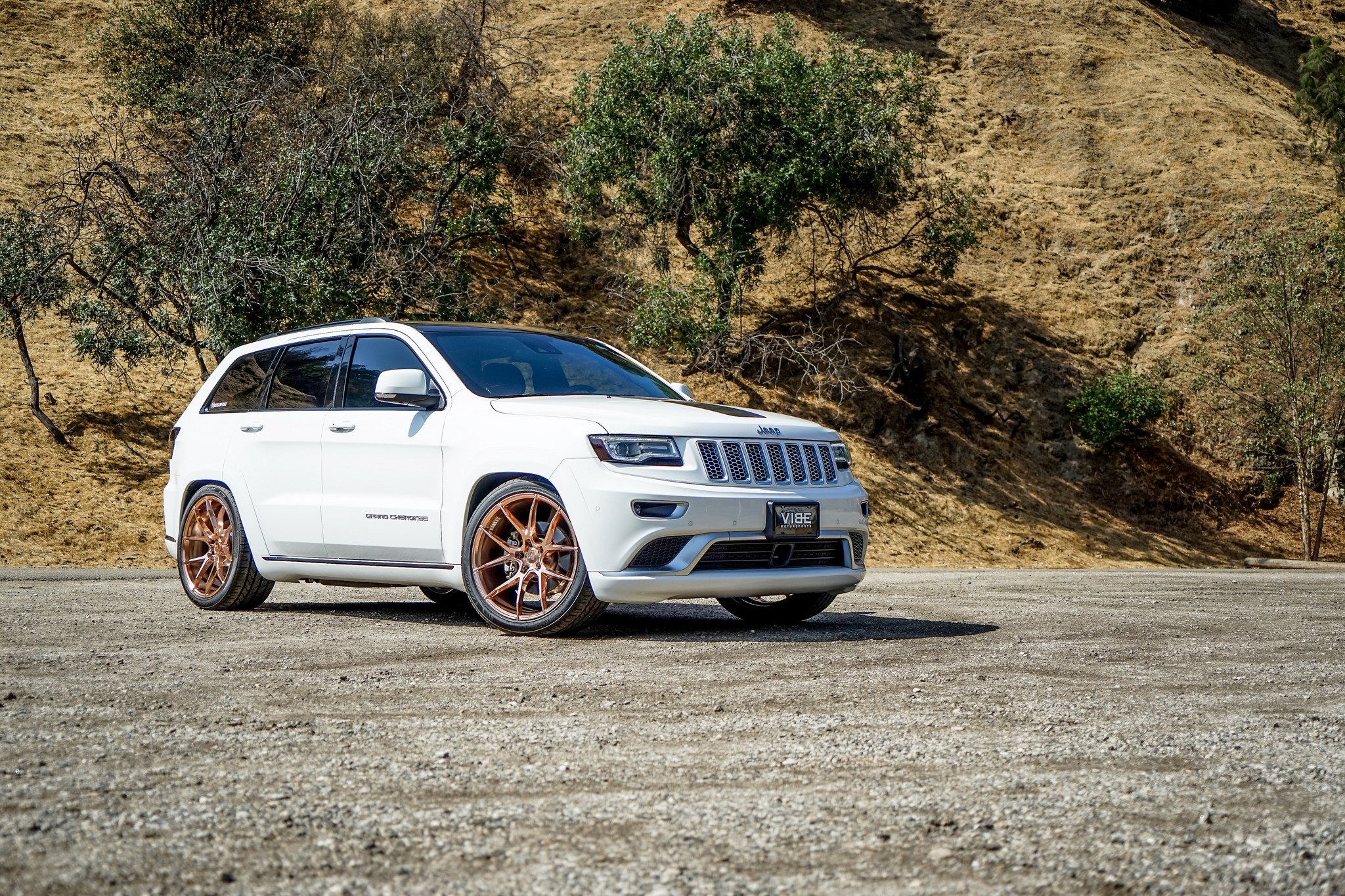 Aftermarket Headlights on White Jeep Grand Cherokee - Photo by VIBE Motorsports