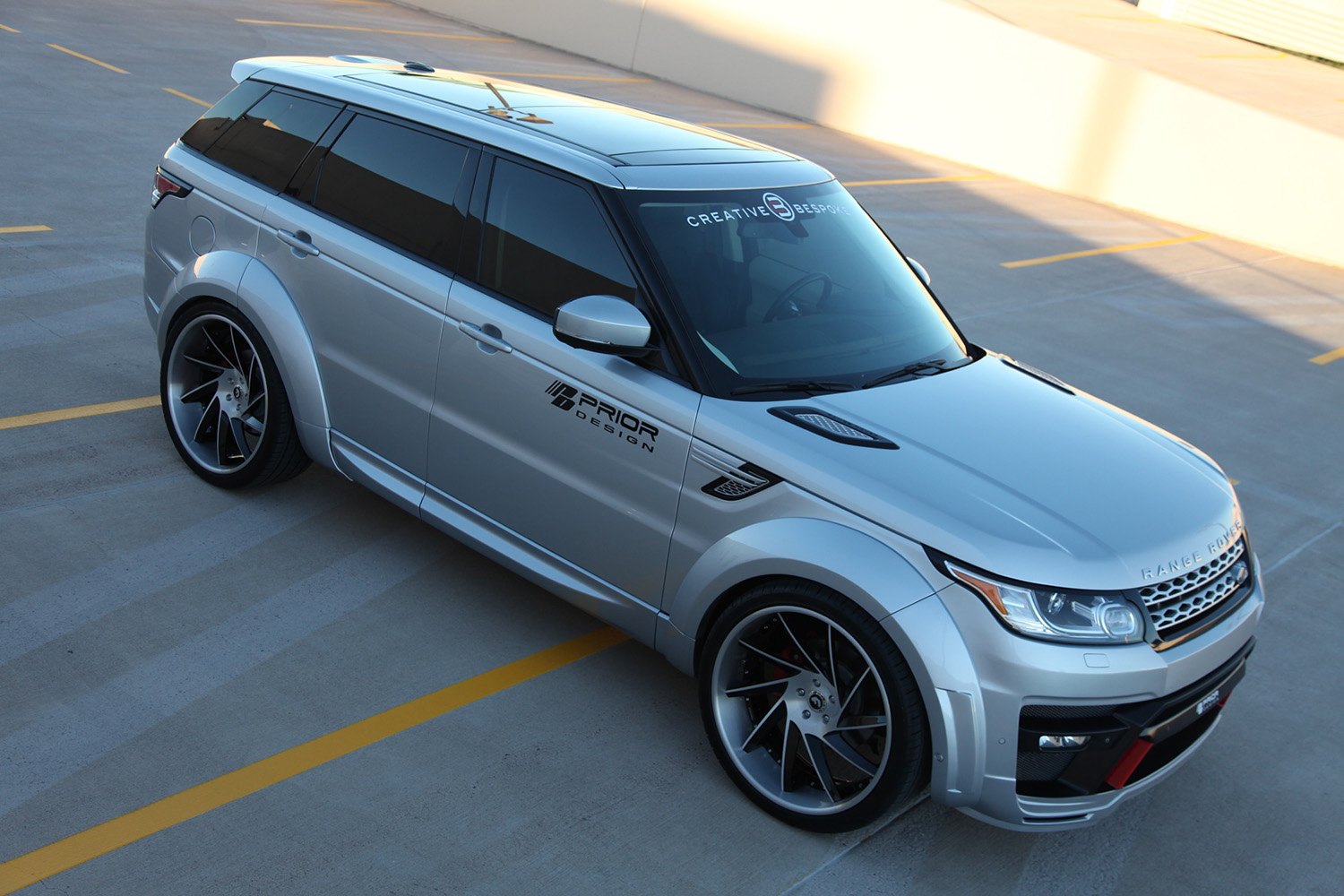 Silver Range Rover Sport with Aftermarket Vented Hood - Photo by Forgiato