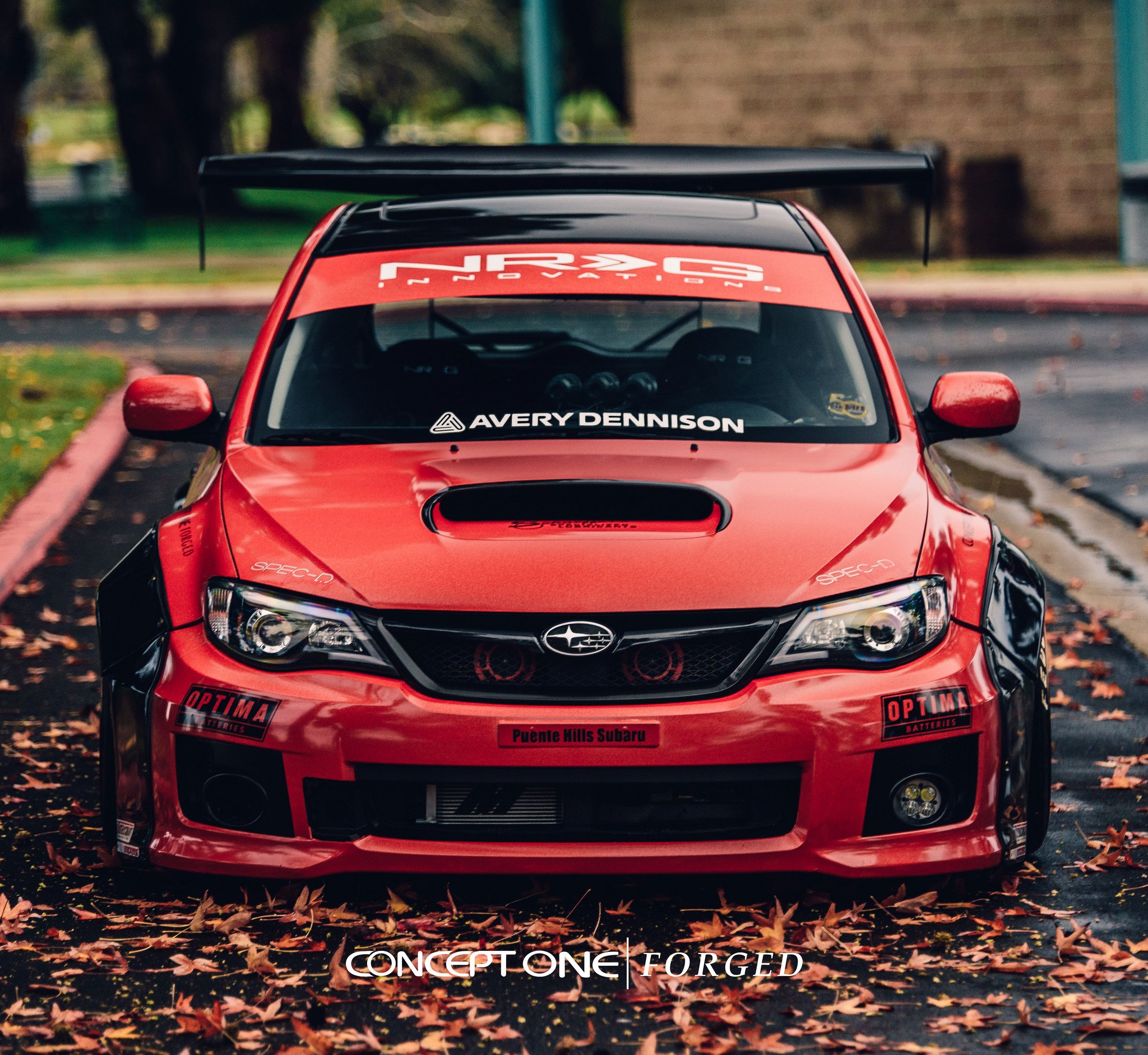Red Debadged Subaru WRX with Aftermarket Hood - Photo by Concept One