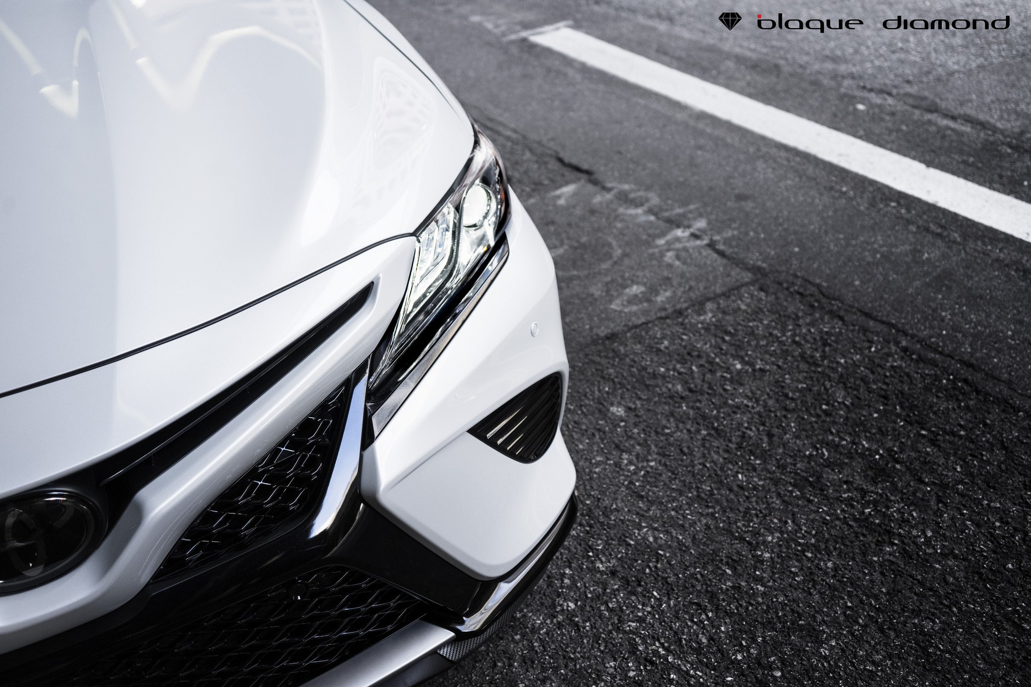 White Toyota Camry with Aftermarket Projector Headlights - Photo by Blaque Diamond Wheels