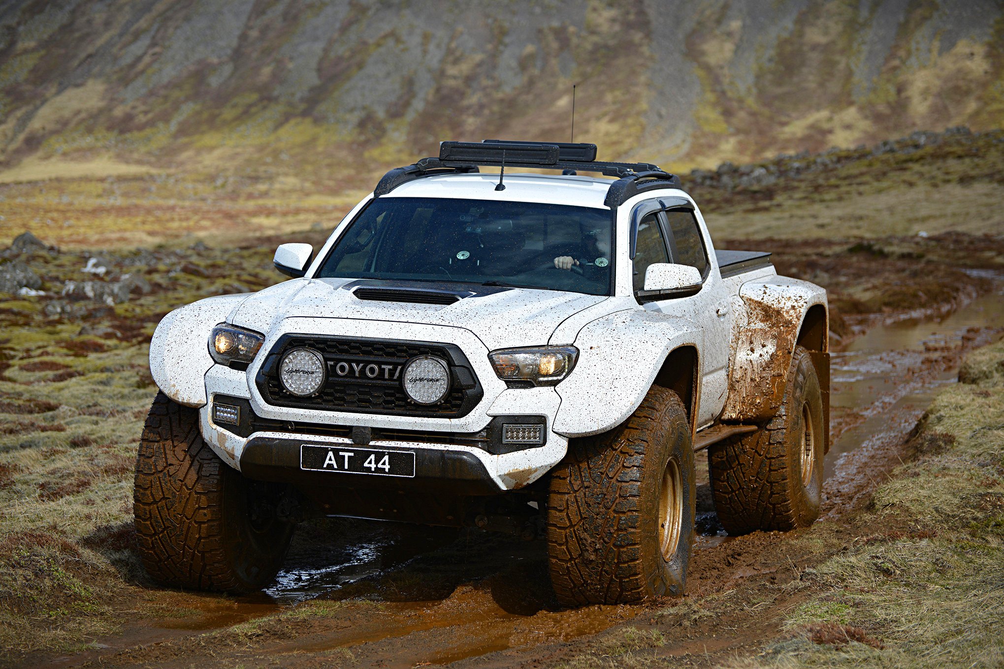White Lifted Toyota Tacoma with Aftermarket Headlights - Photo by fourwheeler.com