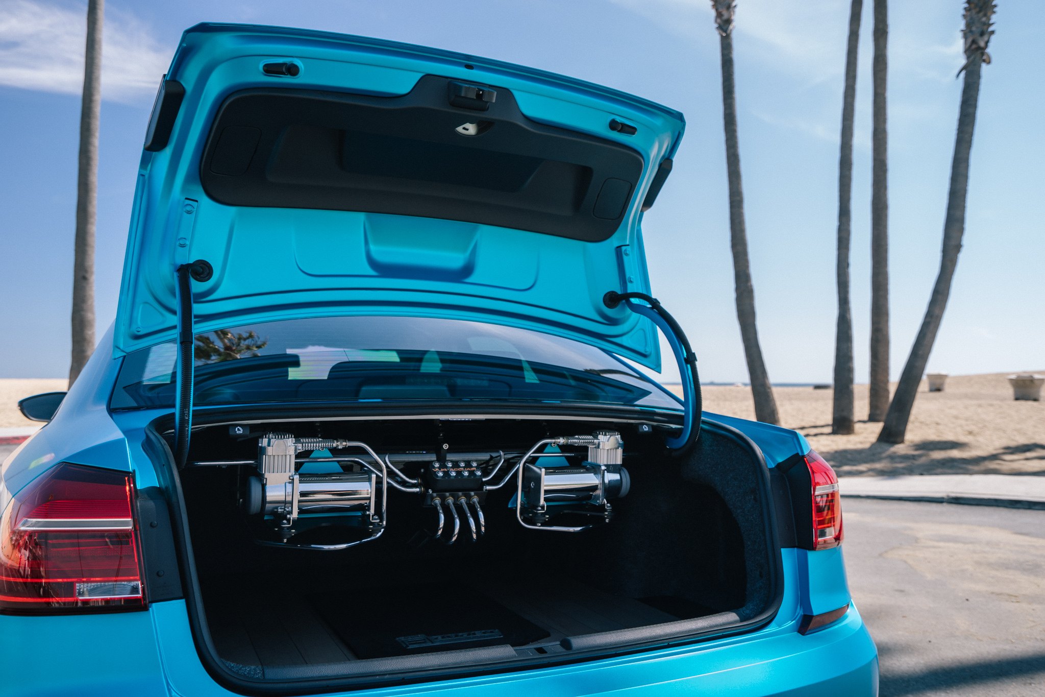 Blue VW Passat with Trunk Accuair Suspension Unit - Photo by Boden Autohaus